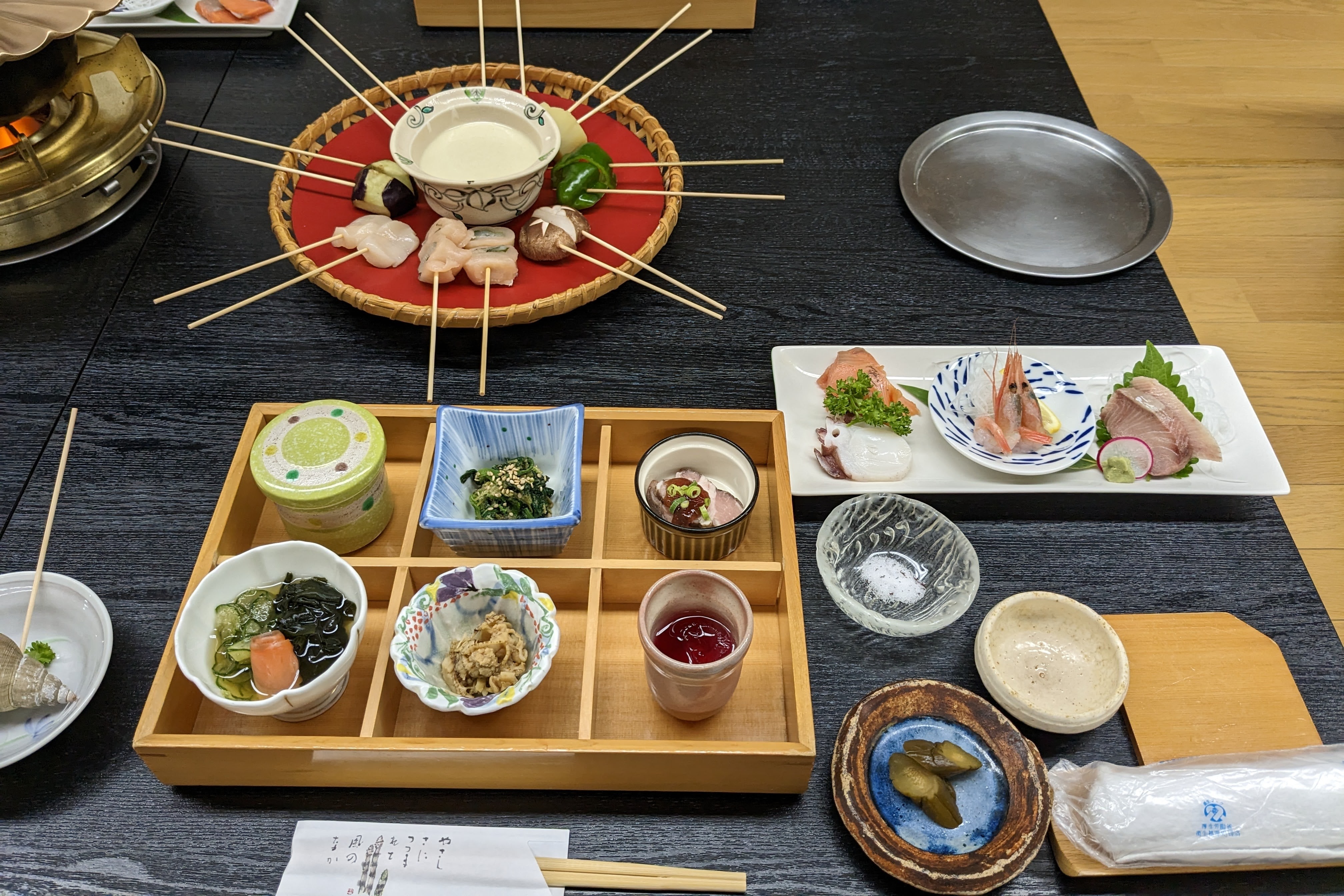 A Japanese "kaiseki" meal, featuring many small and varied dishes spread across a table.