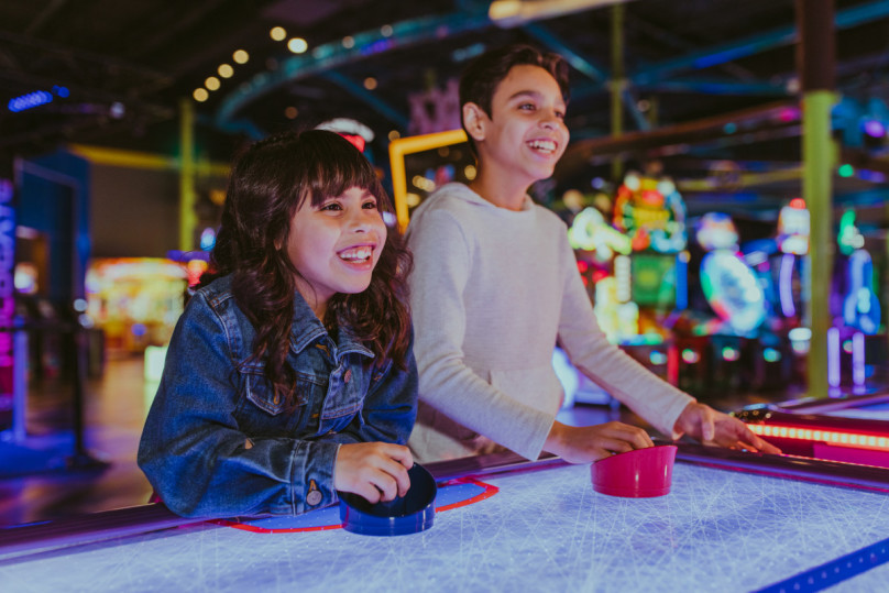 Kids playing Air Hockey at Main Event