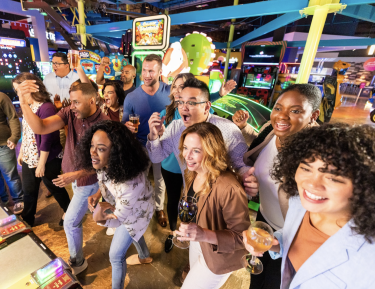 Friend Group playing Skeeball