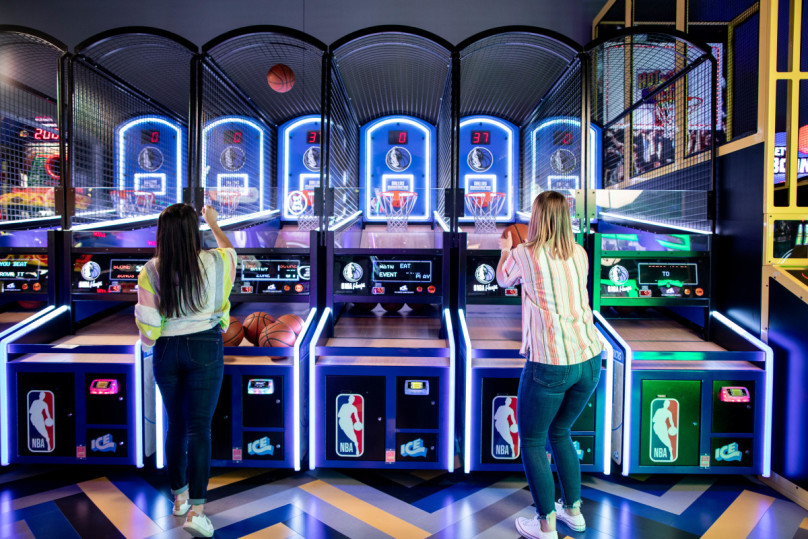 Women playing Basketball game in gaming area