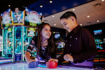 Kids Playing Air Hockey at Main Event