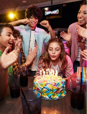 Girl blowing out birthday candles