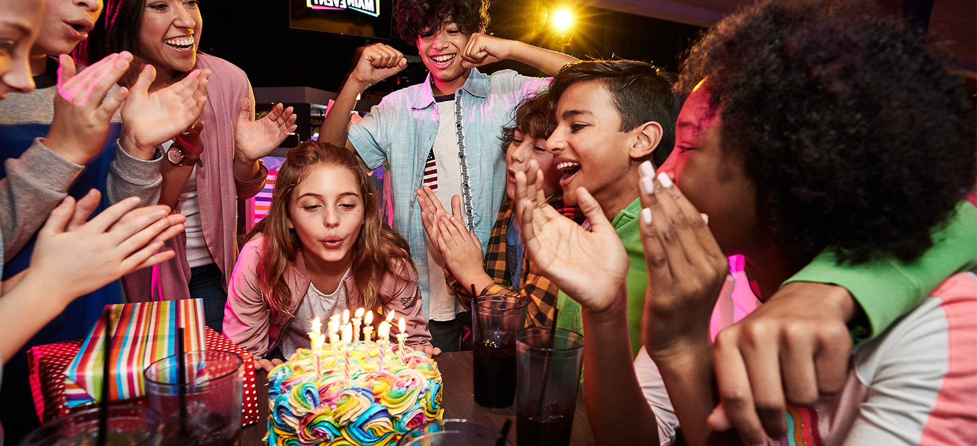 Girl blowing out candles