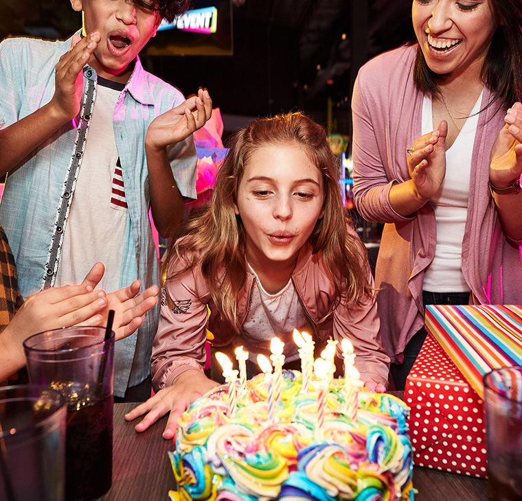 Girl blowing out candles