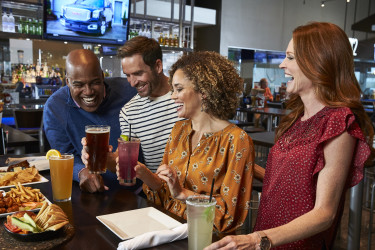 Guests enjoying drinks at the bar