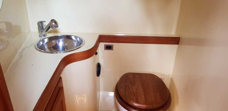 Sanitary room with wash basin and toilet
