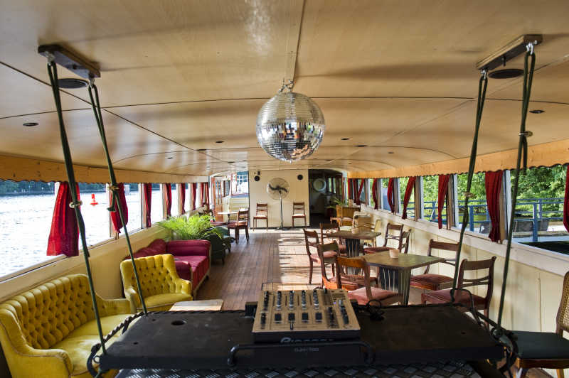 Salon with DJ setup and disco ball on a party ship in Berlin