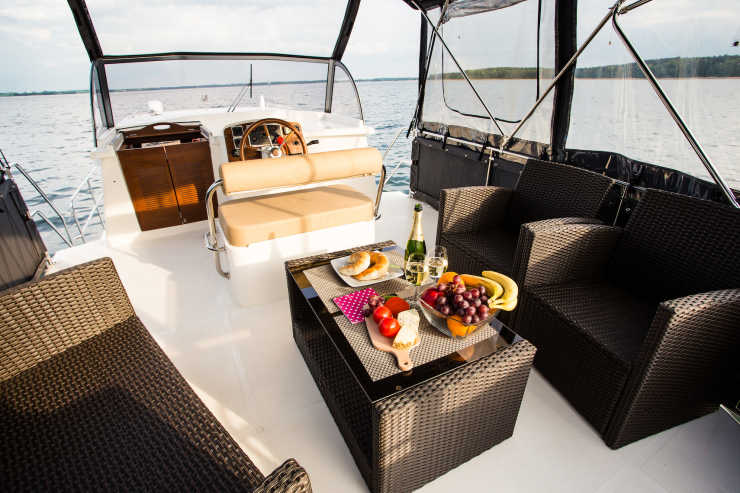 Seating area with fruit plate and sparkling wine on the upper deck of the Nautiner houseboat