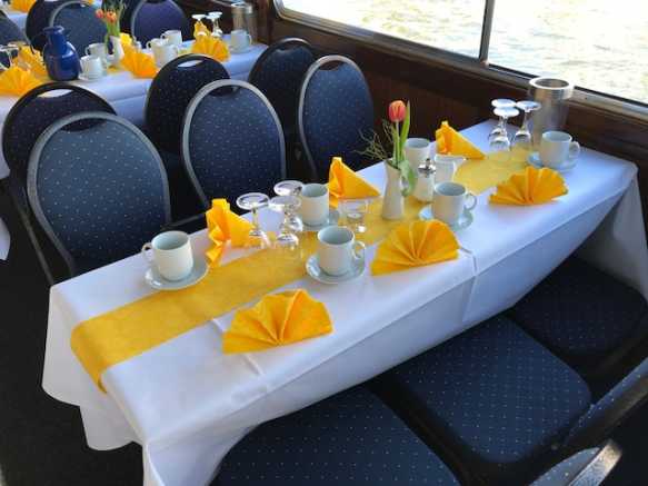 Tables with decoration on the party ship La Belle
