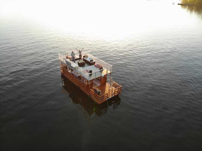Bird's eye view of the Beluga lounge raft in Berlin's sunset on the Havel