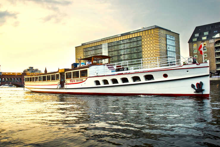 The ship Rhein at sunset on the river Spree in front of the Oberbaum Bridge