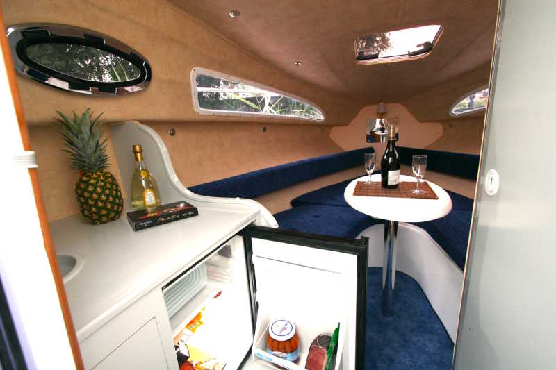 Salon of the motor boat Pia with fridge and sparkling wine