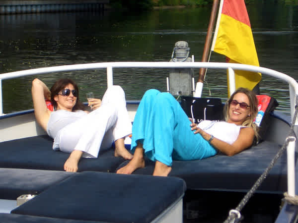Two women bask in the stern of icebreaker Anna
