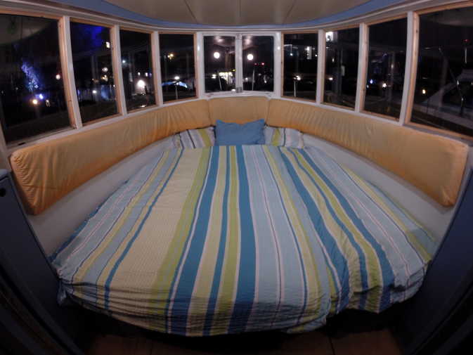 Large bed in the bow cabin of the Rossi houseboat