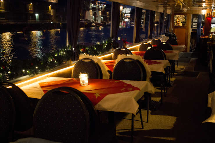 Nächtliche Bootstour auf dem Eventschiff Saga mit gedeckten Tischen und Kerzen