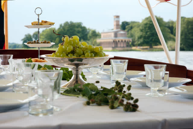 Festliche Tafel auf dem Schiff MS Marple mit der Pfaueninsel im Hintergrund