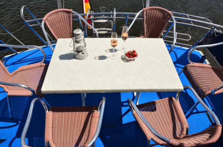 Upper deck with dining table and chairs