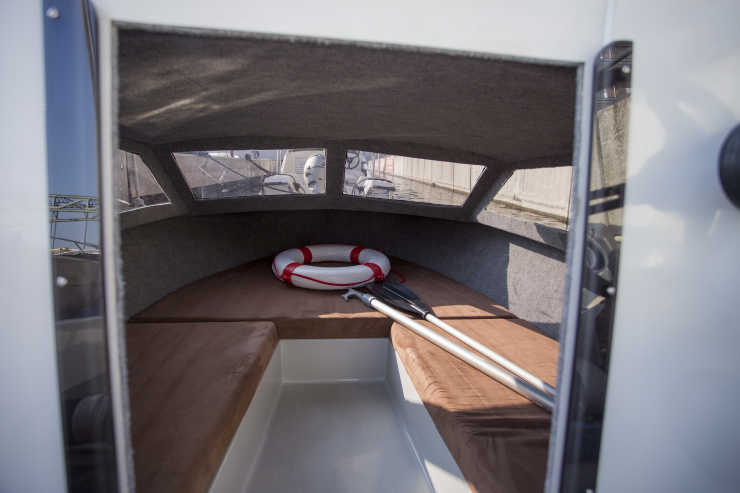 Cabin with lifebuoy and two paddles on the motorboat Sunny in Berlin
