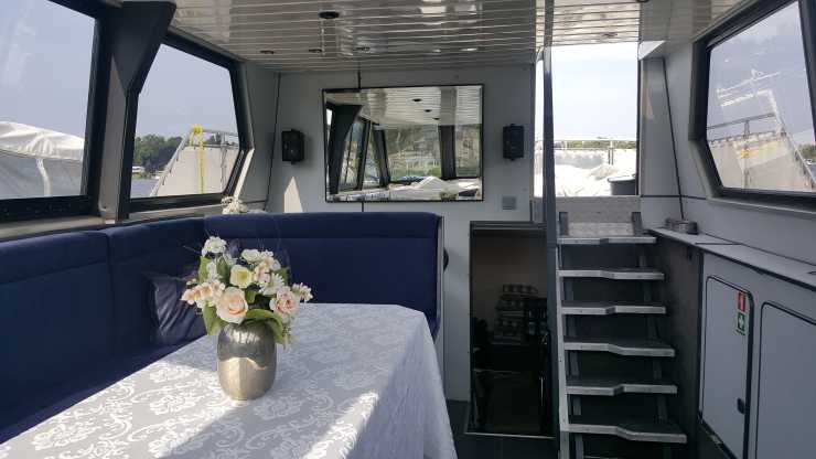 Salon on the Surrender boat with table and flowers