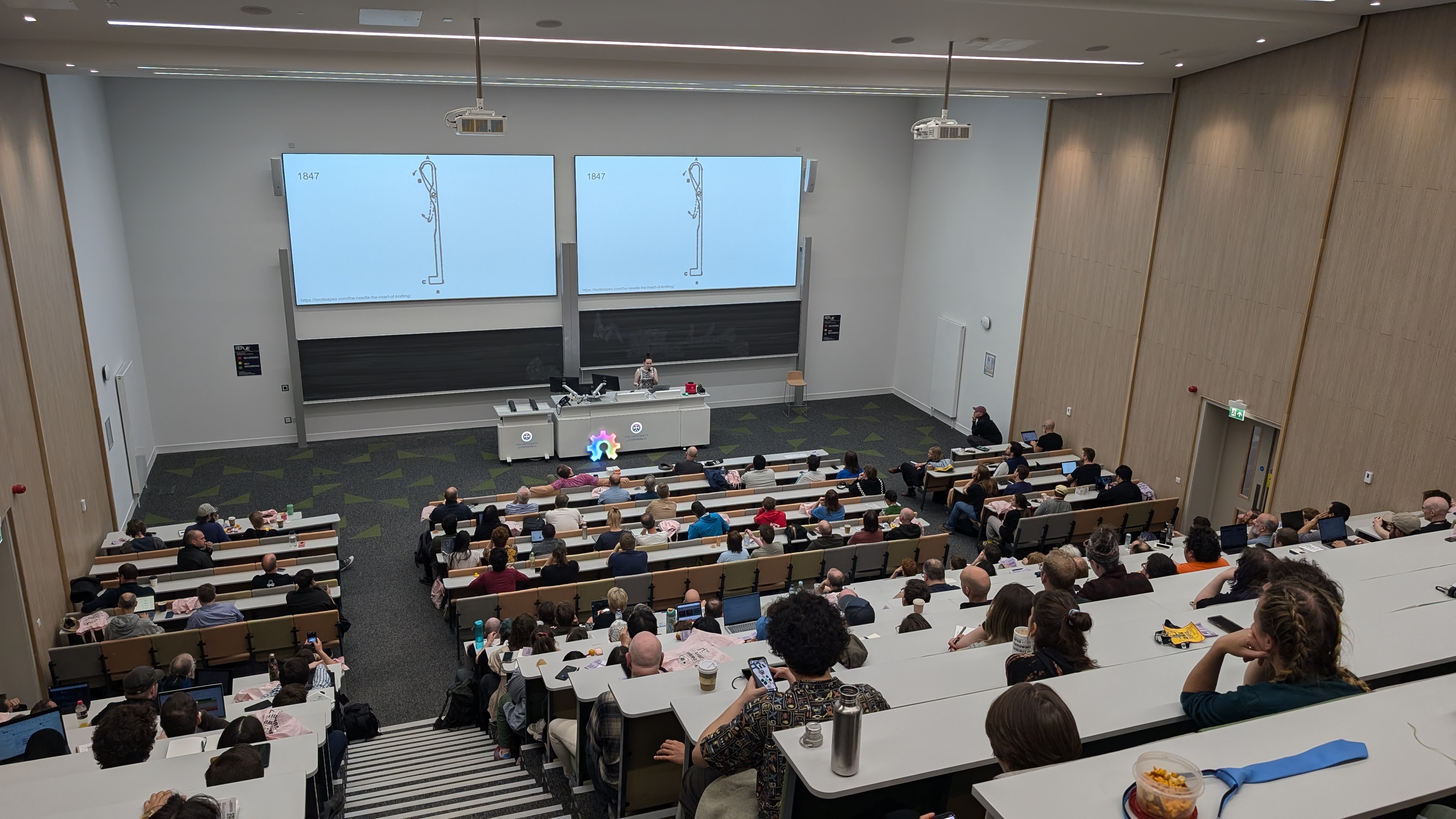 lecture hall full of people watching a talk