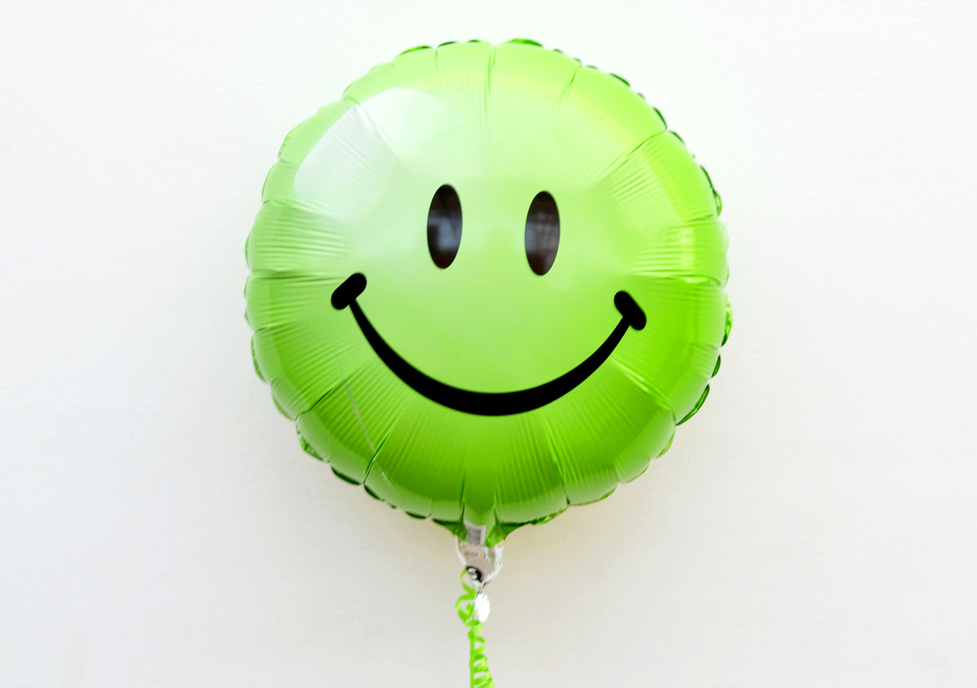 green smiley face balloon