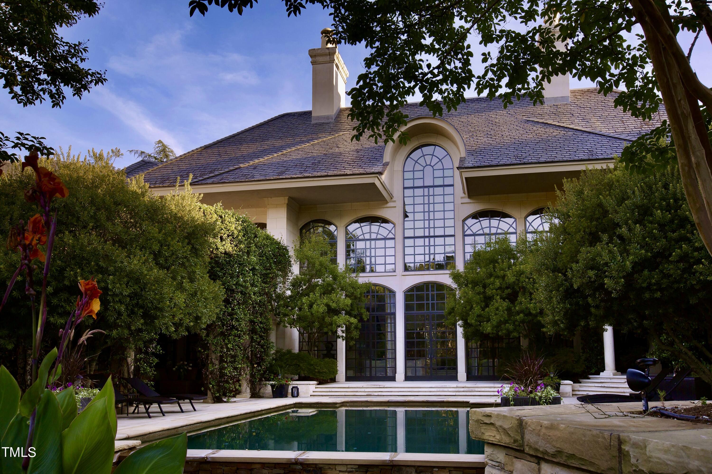 Mansion with pool and large windows. 