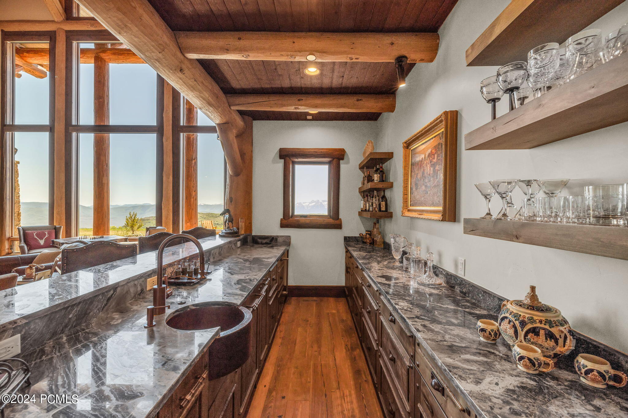 Bar area with stone countertops and wooden panels.