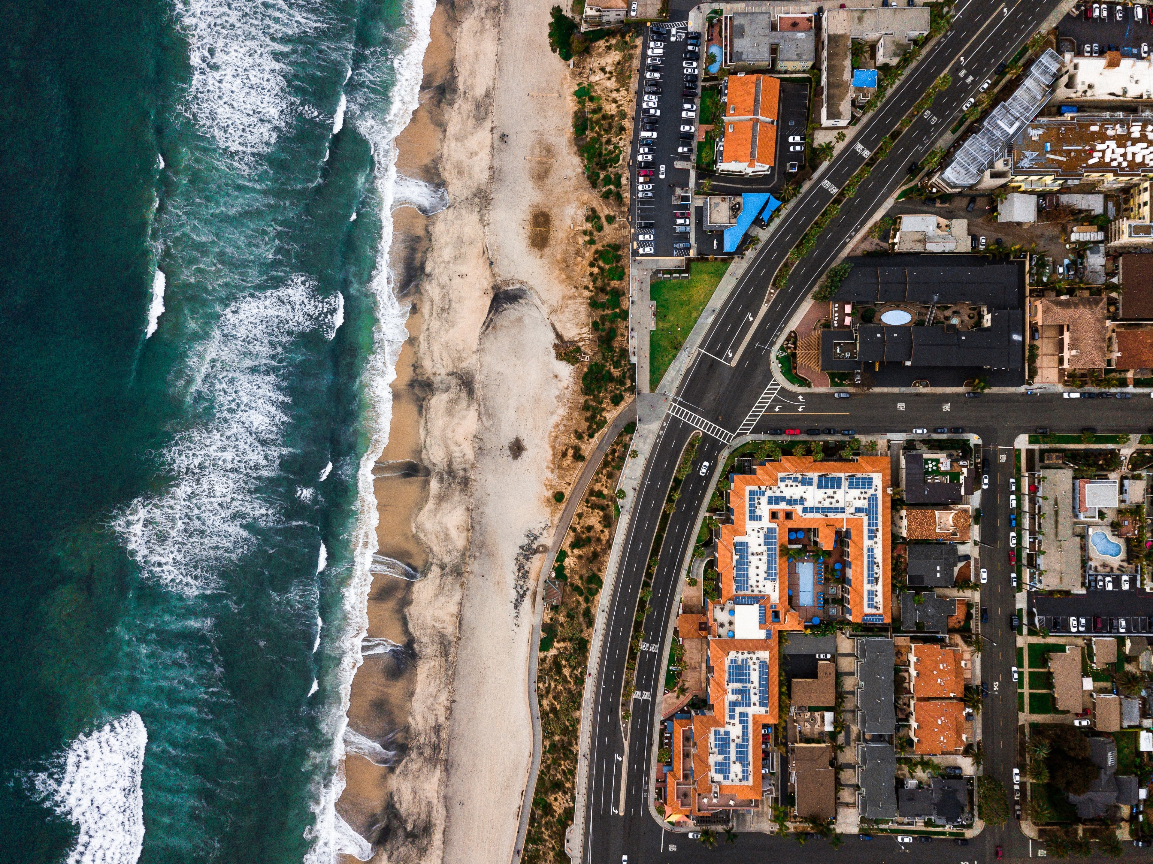 Photo of an overhead view of Carlsbad streets, the beach, and the ocean
