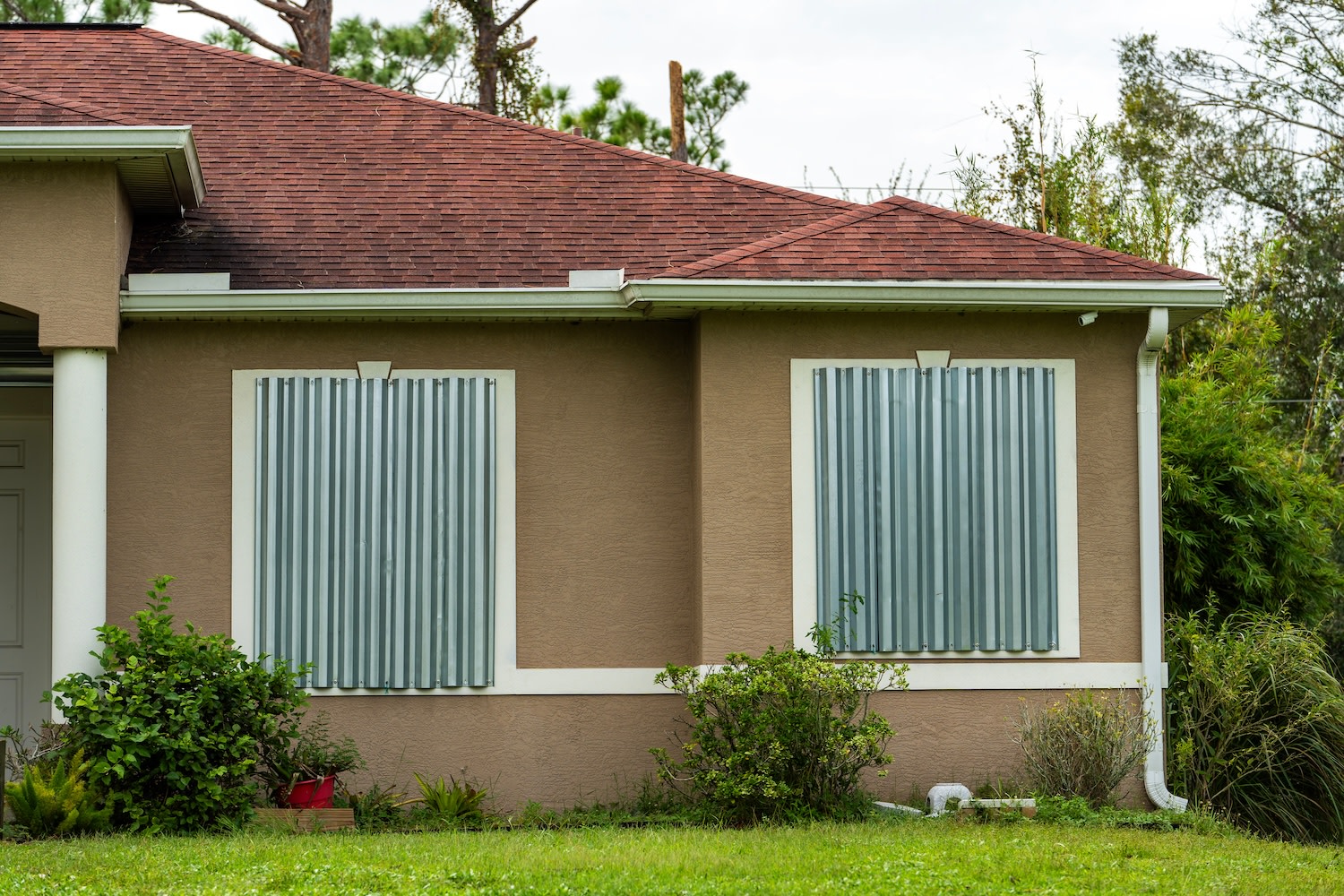 Residential house in Florida with reinforced storm shutters for hurricane protection. Window covering as disaster preparedness