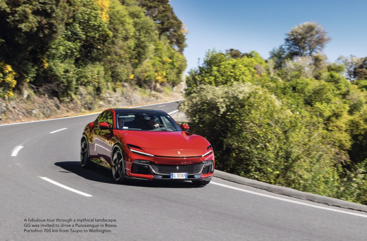 Red Ferrari Purosangue driving around curve 
