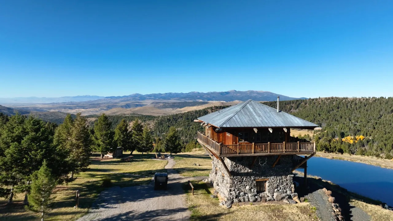 Stone and wooden home in Montana overlooking mountain views.