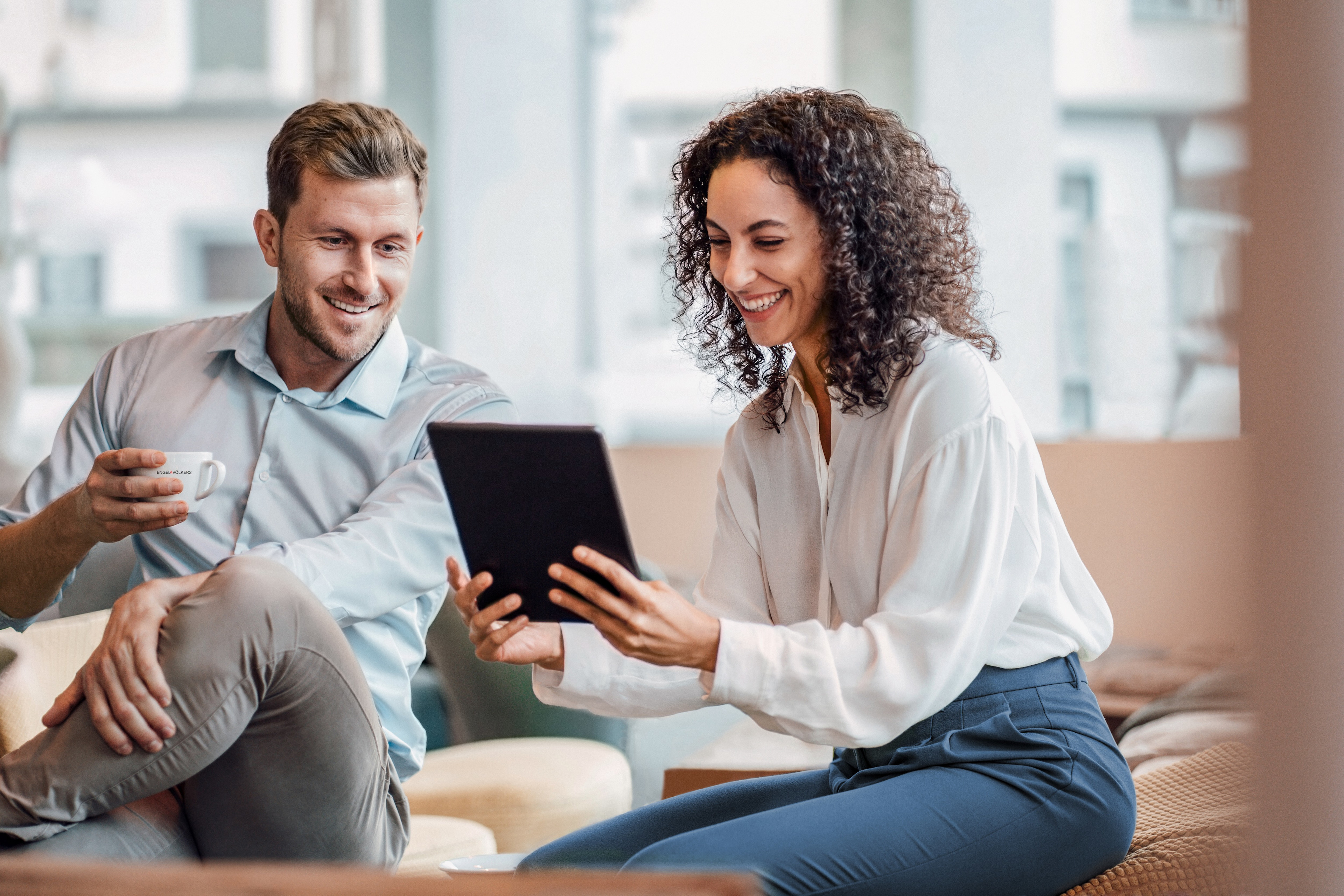 Two real estate agents watching a video