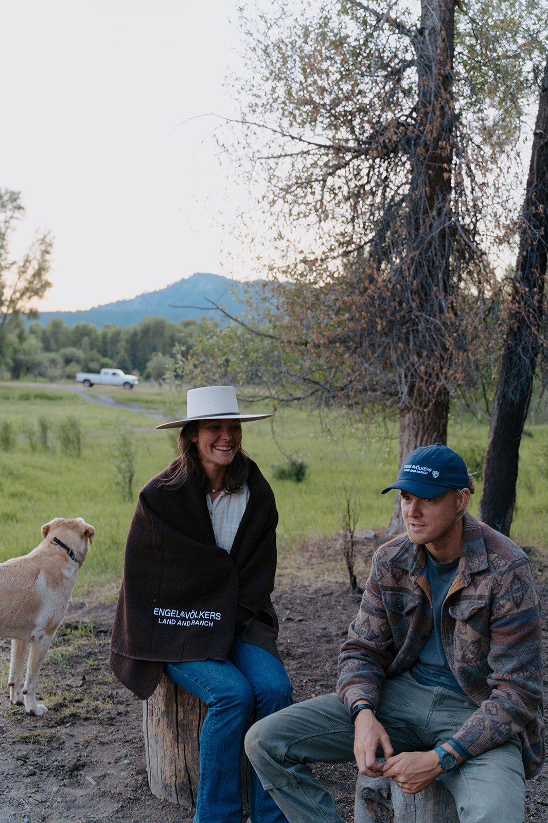 Ranchers sitting with mountains in back