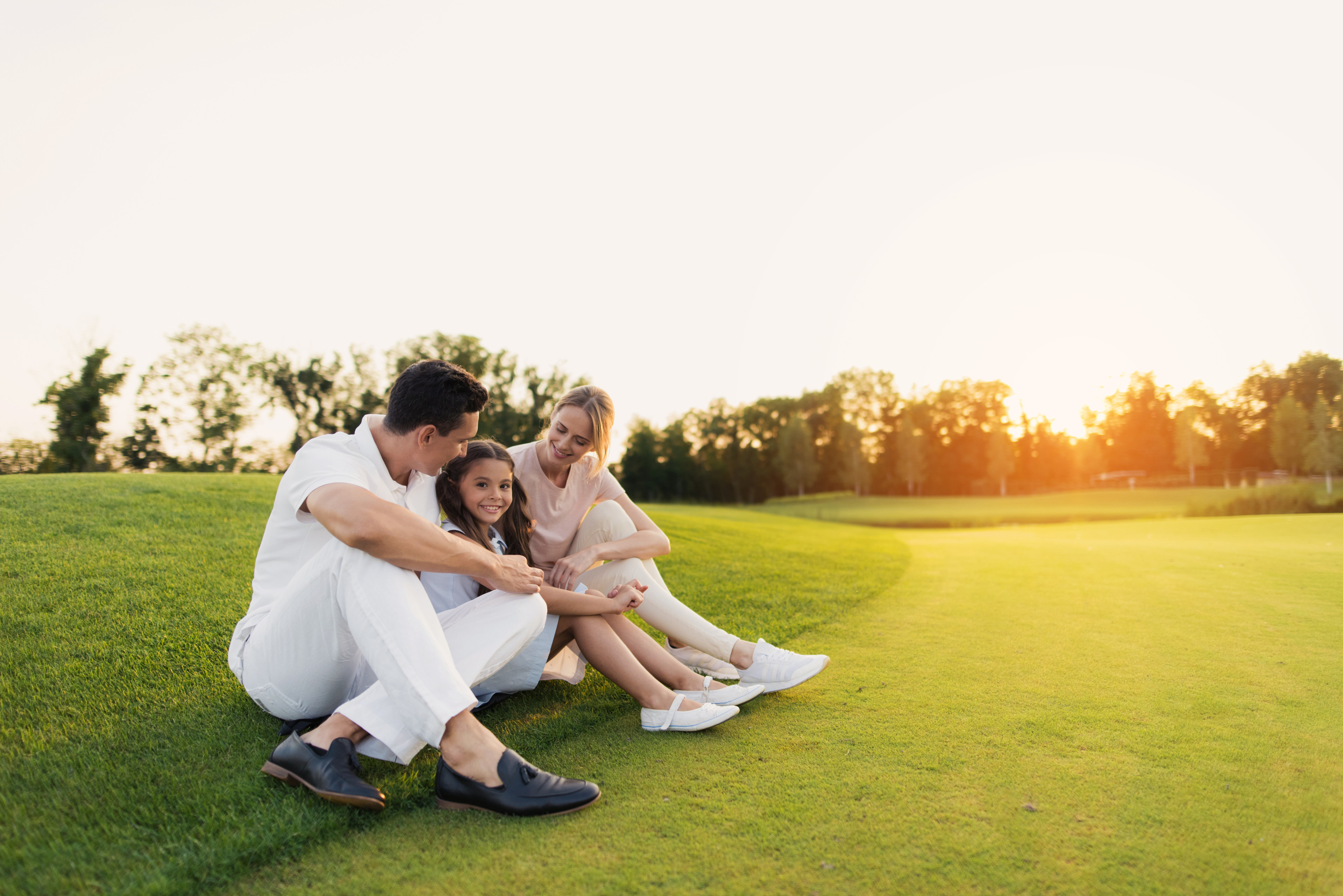 Family sitting on golf course