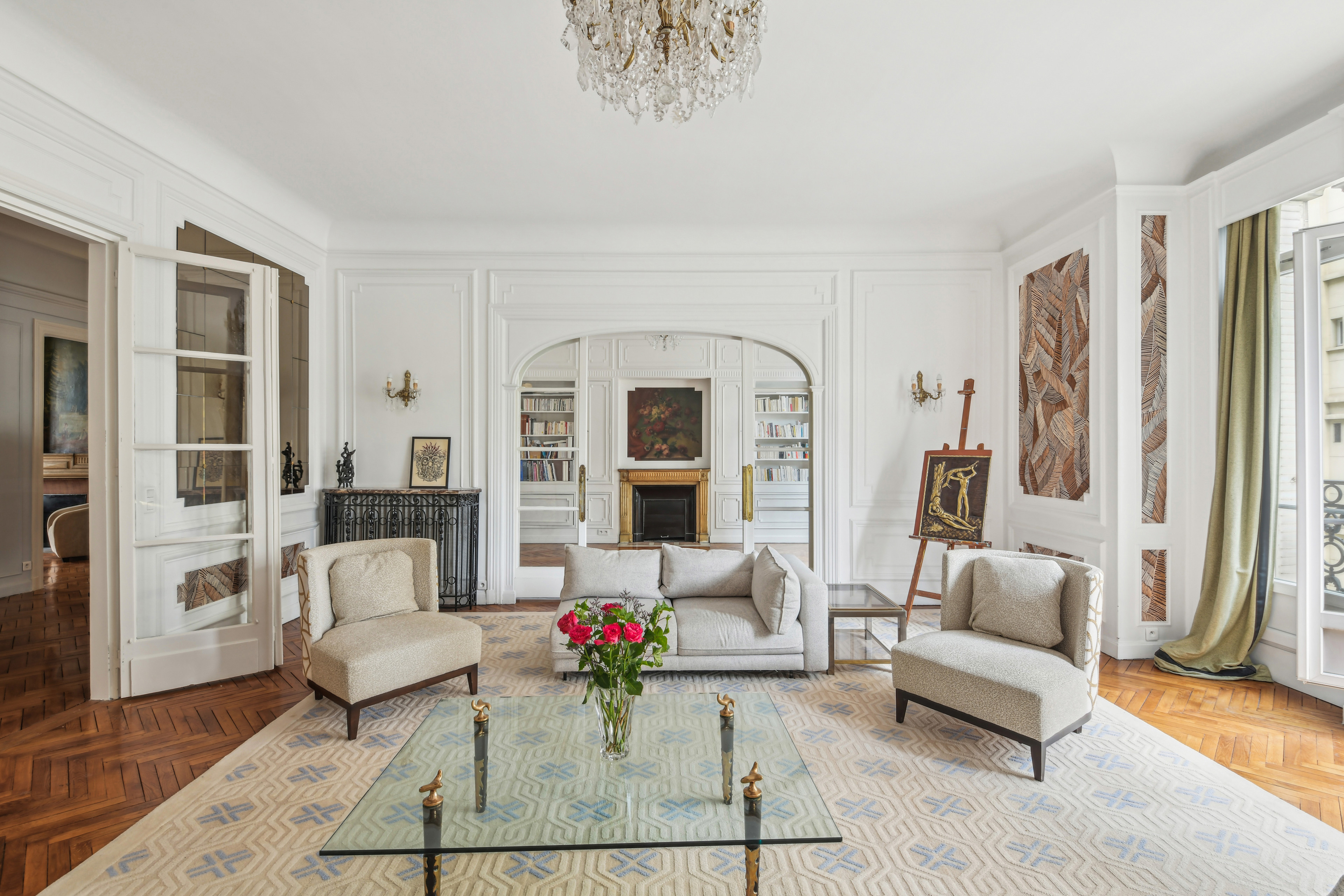 Paris living room with beautiful archways and glass table.