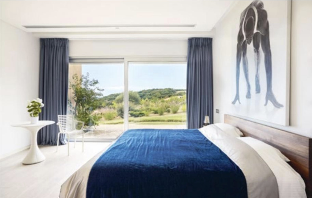 Bedroom with views of green hills 