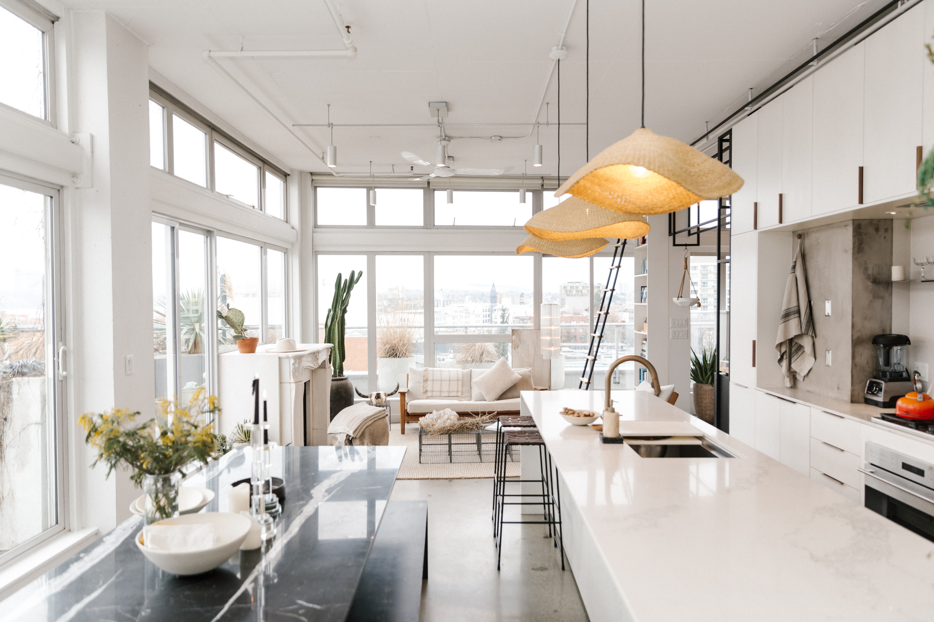 Beautifully staged home with white interior and floor-to-ceiling windows.