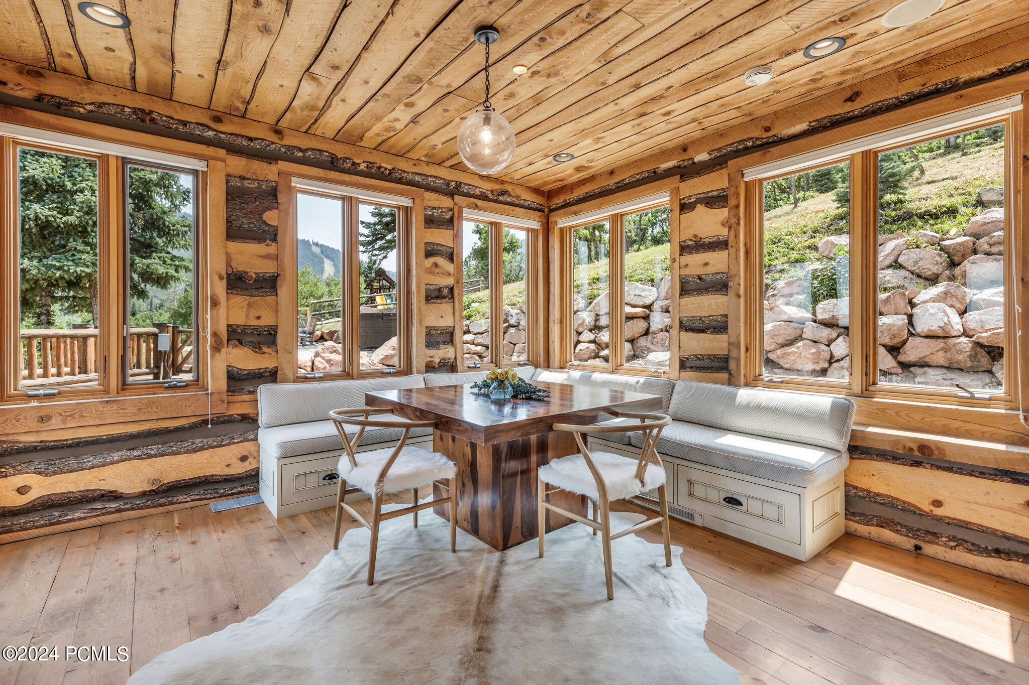 Kitchen with wooden panelling and table.