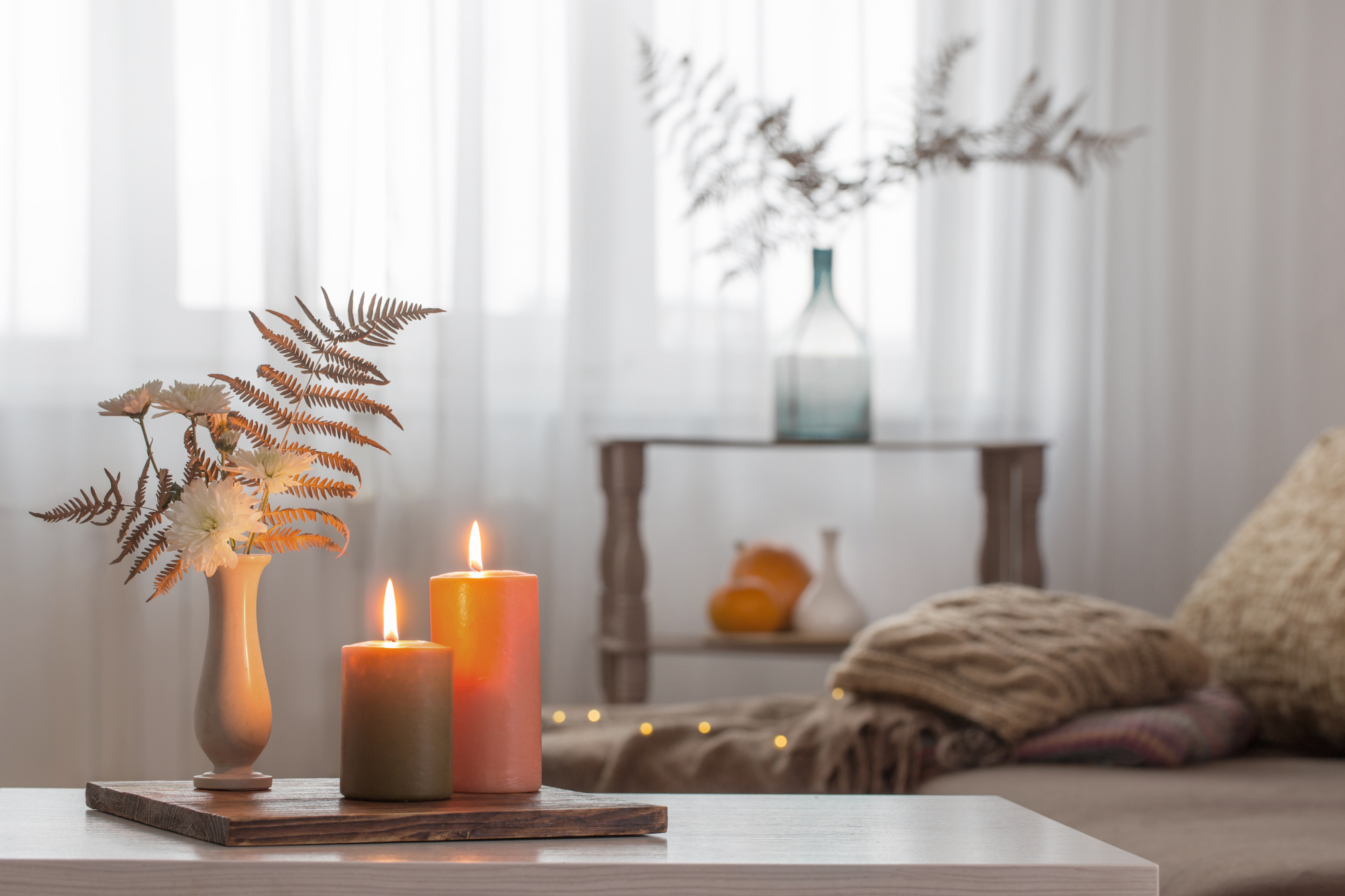 Lit candles with fall decor 