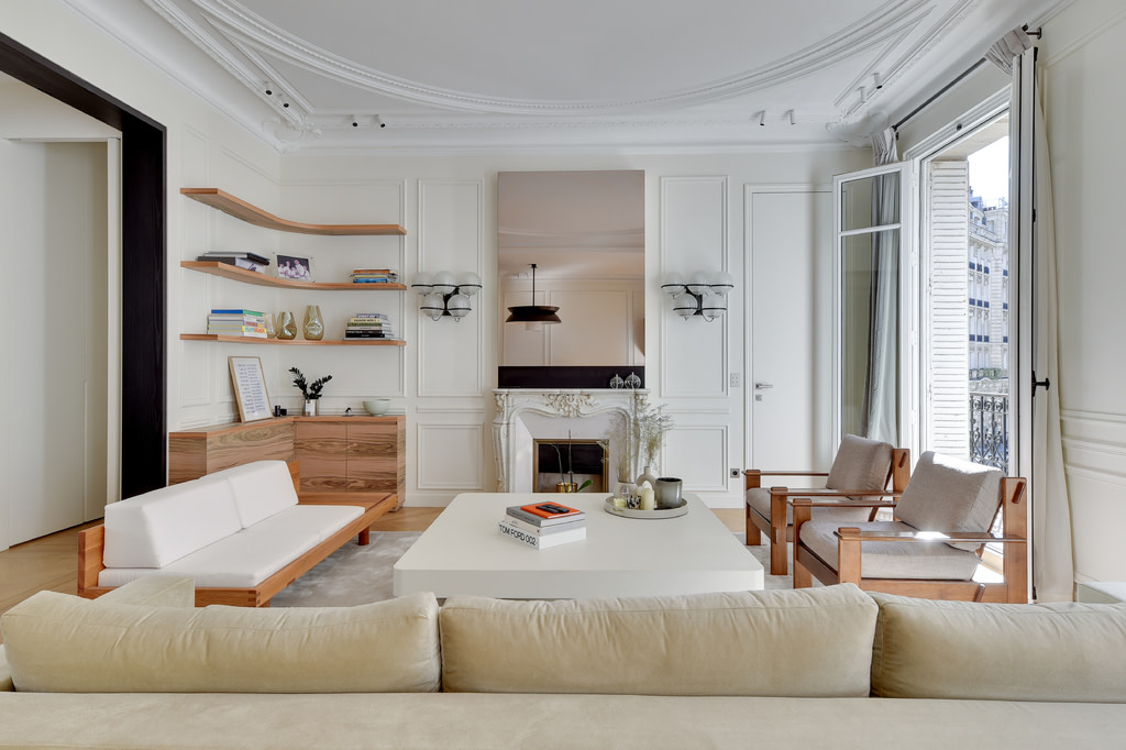 White living room with crown moulding and fireplace.