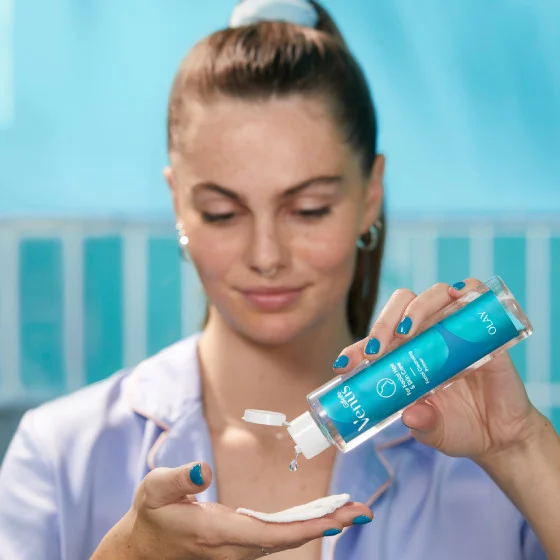 Woman pouring cleanser on her hand
