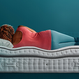 woman lying down on mattress