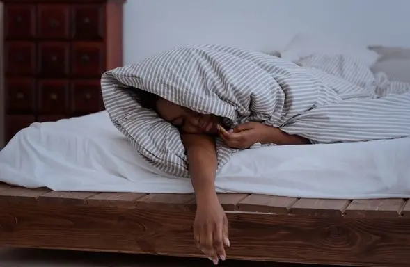 person wrapped in a duvet sleeping