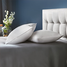 Pillows stacked on top of each other on a premium bed and mattress. 