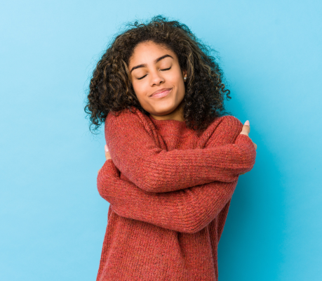 person hugging themselves for self care day
