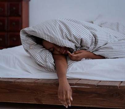 person wrapped up in a duvet sleeping