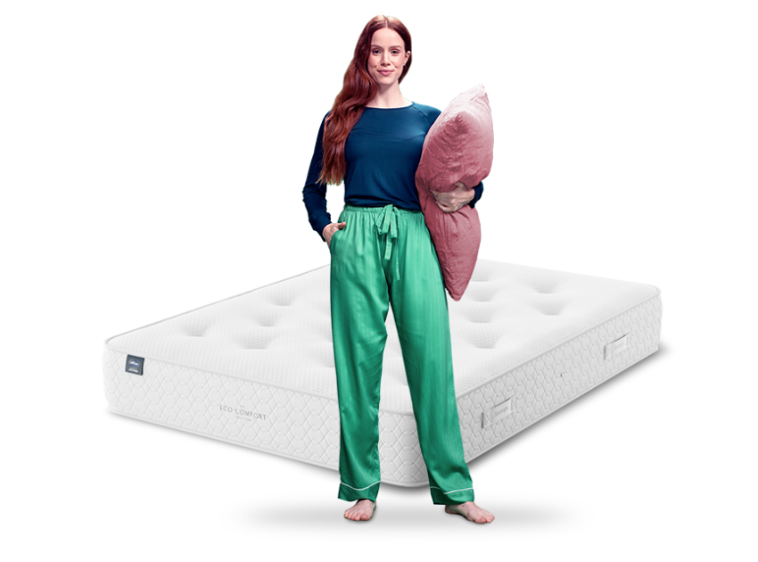 woman in green pyjamas with mattress behind