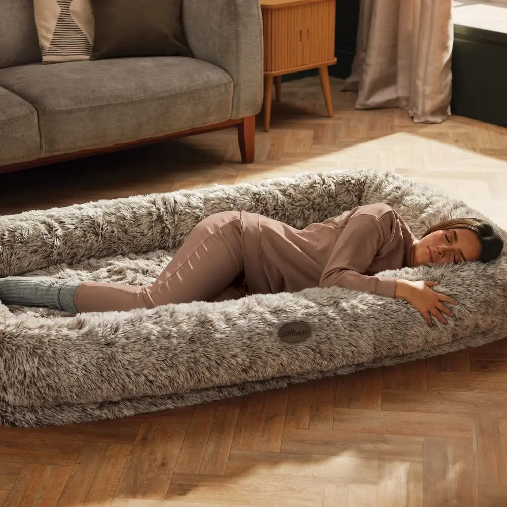 A woman in pyjamas snuggled against the side of the Silentnight snuggle pod