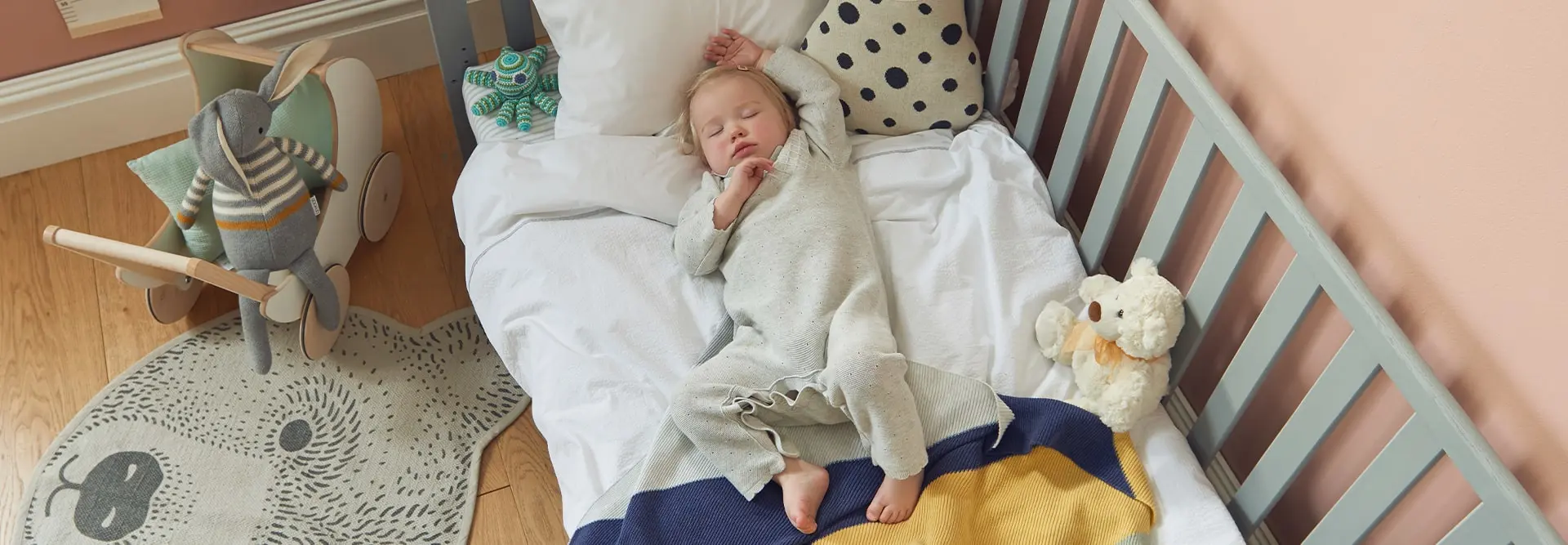 Sleeping baby on a cot bed in a nursery
