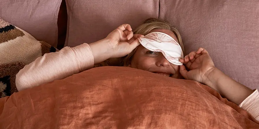 Woman beating insomnia with an eye mask